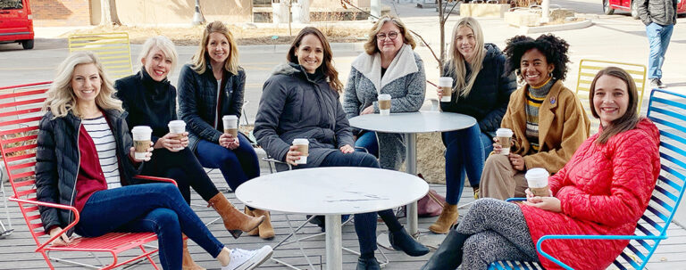 the kidglov team sitting outside, they are a group of women