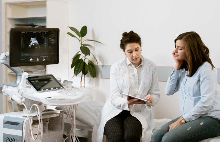 a woman doctor and woman patient sitting together, discussing potential healthcare marketing results