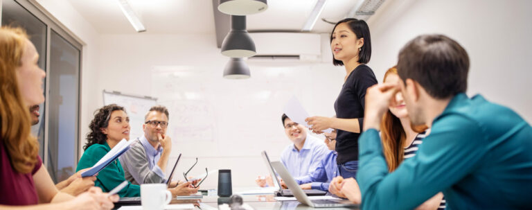 Various business people in a conference room discussing how to use grant dollars