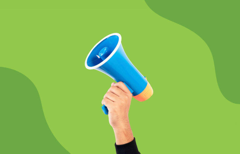 hand holding a megaphone in front of a lime green background
