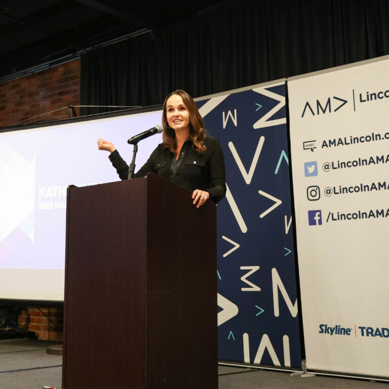 KidGlov employee Katherine Warren accepting an award at AMA Lincoln's Prism Awards.