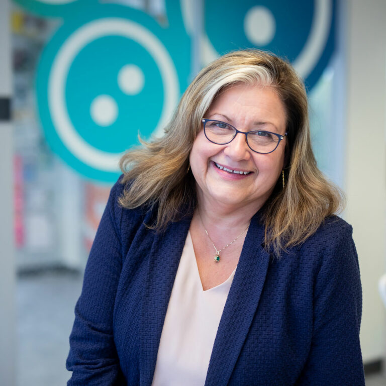 Lyn Wineman smiling in the KidGlov office